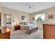 Serene main bedroom featuring plush bedding, soft lighting, and a view to the yard, creating a tranquil retreat at 6908 Stoneywalk Ct, Bradenton, FL 34203