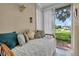 Bright sunroom with daybed and view of the beautifully maintained outdoor landscape at 6908 Stoneywalk Ct, Bradenton, FL 34203