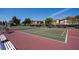 Active community tennis court with manicured court surface, lush greenery, and beautiful buildings at 6908 Stoneywalk Ct, Bradenton, FL 34203