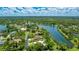 Beautiful aerial view of community with serene lake, lush greenery, and well-maintained homes at 7404 Weeping Willow Blvd, Sarasota, FL 34241