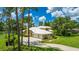 Spacious home boasts a large driveway, well-kept landscaping, and a three-car garage, close to the lake at 7404 Weeping Willow Blvd, Sarasota, FL 34241