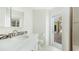 Bathroom featuring a white vanity with decorative mosaic backsplash and exterior door at 7404 Weeping Willow Blvd, Sarasota, FL 34241