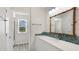 Bathroom featuring a vanity with intricate backsplash and ornate mirror frame at 7404 Weeping Willow Blvd, Sarasota, FL 34241