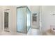 Bathroom with glass-door shower and exit door to backyard pool at 7404 Weeping Willow Blvd, Sarasota, FL 34241