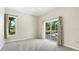 Bedroom featuring carpet and backyard views at 7404 Weeping Willow Blvd, Sarasota, FL 34241