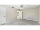 Neutral bedroom featuring gray carpeting and ceiling fan, and a closet door in the background at 7404 Weeping Willow Blvd, Sarasota, FL 34241