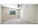 Bedroom with neutral carpet and a large window with natural light at 7404 Weeping Willow Blvd, Sarasota, FL 34241