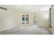 Neutral bedroom with carpet and views of the backyard, pool and french door access at 7404 Weeping Willow Blvd, Sarasota, FL 34241