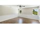 Bedroom with two windows, ceiling fan, and light hardwood flooring at 7404 Weeping Willow Blvd, Sarasota, FL 34241