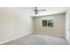 Bedroom with neutral carpet and a large window overlooking the yard at 7404 Weeping Willow Blvd, Sarasota, FL 34241