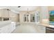 Bright dining area featuring granite countertops, white cabinetry, and a window with a view of the pool area at 7404 Weeping Willow Blvd, Sarasota, FL 34241
