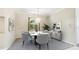 This dining room features a modern chandelier, a table set for six, and an outdoor view at 7404 Weeping Willow Blvd, Sarasota, FL 34241