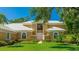 Beautiful home featuring manicured landscaping and an inviting entrance, perfect for making a lasting impression at 7404 Weeping Willow Blvd, Sarasota, FL 34241