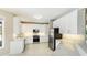 Modern kitchen with stainless steel appliances, granite countertops, and white cabinets at 7404 Weeping Willow Blvd, Sarasota, FL 34241