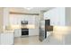 Stylish kitchen featuring white cabinets, stainless steel appliances, and granite countertops at 7404 Weeping Willow Blvd, Sarasota, FL 34241