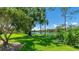Breathtaking view of the lake featuring a lush green lawn in the foreground at 7404 Weeping Willow Blvd, Sarasota, FL 34241