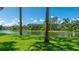 Picturesque view of the lake featuring a grassy shoreline at 7404 Weeping Willow Blvd, Sarasota, FL 34241
