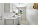 Bright laundry room featuring a sink, modern washer and dryer and plenty of storage cabinets at 7404 Weeping Willow Blvd, Sarasota, FL 34241