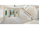 Bright living room featuring a staircase and pool views through French doors at 7404 Weeping Willow Blvd, Sarasota, FL 34241