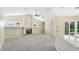 Bright living room featuring high ceilings, fireplace, and sliding glass doors to the lanai at 7404 Weeping Willow Blvd, Sarasota, FL 34241