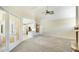 Open-concept living room providing seamless access to kitchen with view to pool at 7404 Weeping Willow Blvd, Sarasota, FL 34241