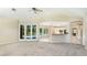 Open living area with pool views, kitchen access and access to outdoor areas at 7404 Weeping Willow Blvd, Sarasota, FL 34241