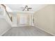 Spacious living room with neutral carpet, staircase and elegant double door entry at 7404 Weeping Willow Blvd, Sarasota, FL 34241