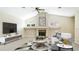 A comfortable living room with vaulted ceiling, fireplace, and contemporary decor at 7404 Weeping Willow Blvd, Sarasota, FL 34241