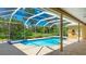 Stunning screened-in pool with a spa and brick paved deck with picturesque views of the backyard at 7404 Weeping Willow Blvd, Sarasota, FL 34241