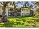 This backyard boasts a spacious lawn, providing an ideal setting for relaxation and outdoor activities at 7866 Eagle Creek Dr # 7866, Sarasota, FL 34243