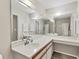 Bathroom view showing expansive mirror, a vanity area, and neutral wall color at 7866 Eagle Creek Dr # 7866, Sarasota, FL 34243