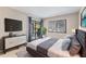 This main bedroom features blue drapes and lots of natural light through a large window at 7866 Eagle Creek Dr # 7866, Sarasota, FL 34243