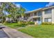 Inviting condo building with well-kept lawns, stairs to upper units, and freshly painted doors at 7866 Eagle Creek Dr # 7866, Sarasota, FL 34243