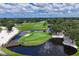 Picturesque golf course showcasing a pond with a fountain, bridge, and lush greenery under a partly cloudy sky at 7866 Eagle Creek Dr # 7866, Sarasota, FL 34243