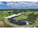Scenic golf course view featuring lush greens, water hazards, and beautiful landscaping under a partly cloudy sky at 7866 Eagle Creek Dr # 7866, Sarasota, FL 34243
