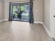 Light-filled living room showcasing wood floors and sliding glass doors to an outdoor balcony at 7866 Eagle Creek Dr # 7866, Sarasota, FL 34243