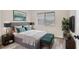 This main bedroom includes modern décor, a large bed, and beautiful wood-look floors at 7866 Eagle Creek Dr # 7866, Sarasota, FL 34243