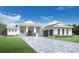Stunning single-story home features a paver driveway, lush landscaping and a welcoming front porch at 8045 Nevis Run, Bradenton, FL 34202