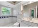 Bathroom features a tile shower with glass door, toilet, vanity, and a large mirror at 8102 Waterview Blvd, Lakewood Ranch, FL 34202