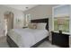 Bedroom with comfortable bed, large windows, and neutral-toned decor at 8102 Waterview Blvd, Lakewood Ranch, FL 34202