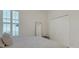 Bedroom featuring shuttered windows, ample closet space, and soft decor for a bright and airy feel at 8102 Waterview Blvd, Lakewood Ranch, FL 34202