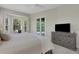 Bright bedroom with a window seat, sliding doors to outdoor area, and ceiling fan at 8102 Waterview Blvd, Lakewood Ranch, FL 34202