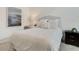 Inviting bedroom with soft textures, stylish artwork and a bedside table at 8102 Waterview Blvd, Lakewood Ranch, FL 34202