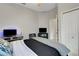 Bedroom featuring an open door and TV, offering a blend of style and convenience at 8102 Waterview Blvd, Lakewood Ranch, FL 34202