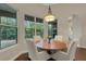 Charming dining area features hardwood floors, natural light, and views of lush landscaping at 8102 Waterview Blvd, Lakewood Ranch, FL 34202