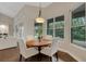 Dining area with hardwood floors, white chairs, and view of backyard patio at 8102 Waterview Blvd, Lakewood Ranch, FL 34202