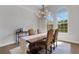 Elegant dining room featuring a modern chandelier and large windows, creating a warm atmosphere at 8102 Waterview Blvd, Lakewood Ranch, FL 34202
