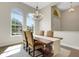 Charming dining area with large windows, stylish light fixture, and seating for six at 8102 Waterview Blvd, Lakewood Ranch, FL 34202