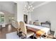 Bright dining room featuring hardwood floors, a modern chandelier, and lots of natural light at 8102 Waterview Blvd, Lakewood Ranch, FL 34202