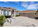 An exterior view of the home showcasing the terracotta roof, three-car garage and inviting driveway at 8102 Waterview Blvd, Lakewood Ranch, FL 34202